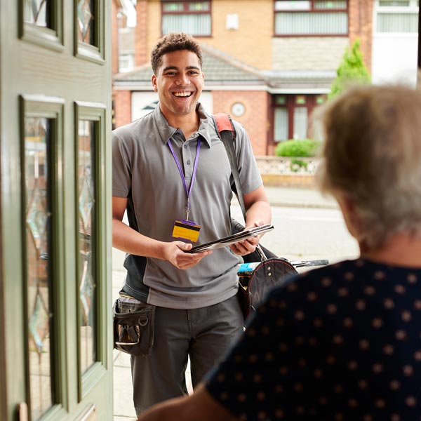 Homeowner welcoming the plumber at the front door for repair service in Olympia, WA