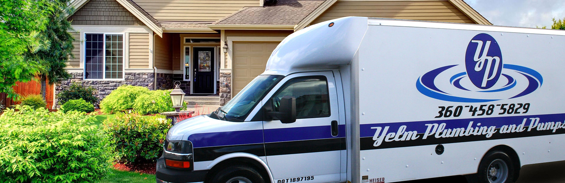Yelm Plumbing and Pumps work truck outside a home