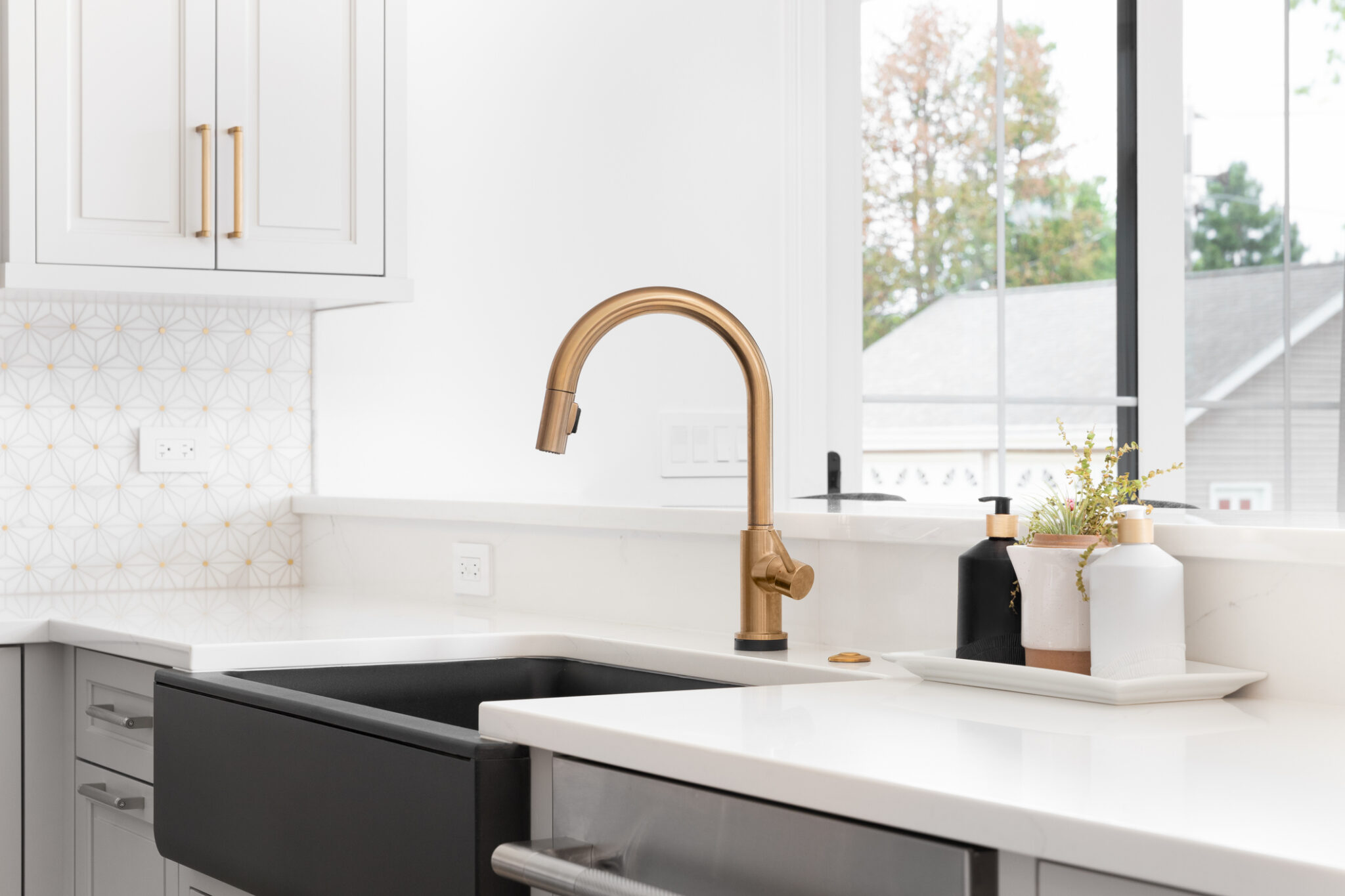Gold Faucet and Modern Farmhouse Sink in remodeled kitchen